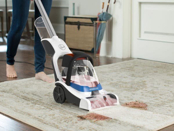 Carpet shampoo machine cleaning a rug